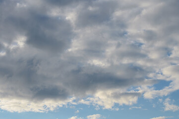 Abstract background of white fluffy clouds on a bright blue sky