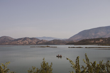 Butrint National Park, Albania. Archaeological open-air museum. Ancient city. Men are fishing in the lake