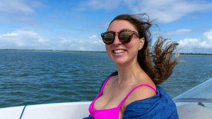 Young blonde smiling in a boat in Aracaju, Sergipe, Brazil.