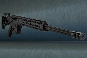 Modern powerful sniper rifle on a light background, close-up.