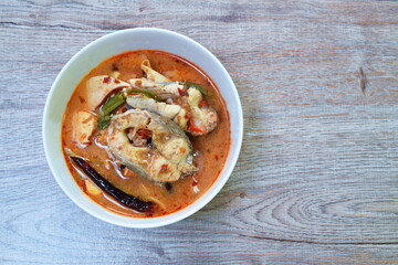 spicy boiled snake head fish meat and slice coconut shoot in tom yum soup on bowl
