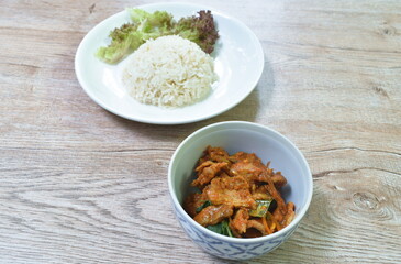 spicy boiled dunk meat in spicy Thai southern spice curry eat couple steamed ginger rice on plate
