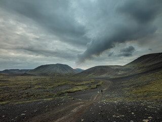 Volcano eruption site with a visible column of smoke, seen from a few kilometres.