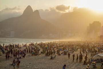 tourists on Ipanema beach at dusk. Rio de Janeiro, Brazil.
