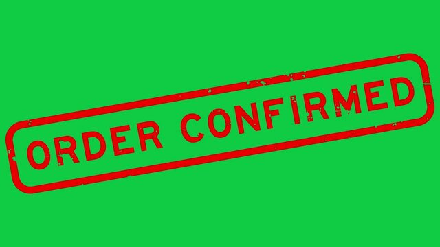 Grunge red order confirmed word rubber stamp zoom on green background