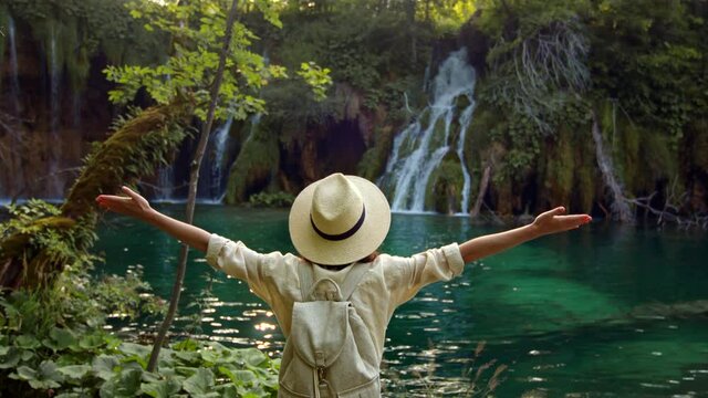 Young woman in a hat on the wooden bridge, slow motion video