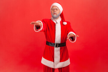 Vision problems. Portrait of blind disoriented lonely elderly man in santa claus costume walking...