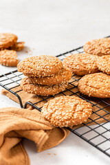 Homemade oatmeal cookies with sesame seeds on a grey background. Tasty sweet breakfast, healthy food. Copy space