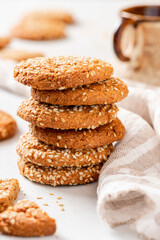 Fototapeta na wymiar Homemade oatmeal cookies with sesame seeds close-up. Tasty sweet breakfast, healthy food.