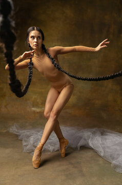 Expressive passionate woman, professional ballet dencer isolated over vintage background