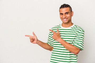 Young venezuelan man isolated on white background excited pointing with forefingers away.