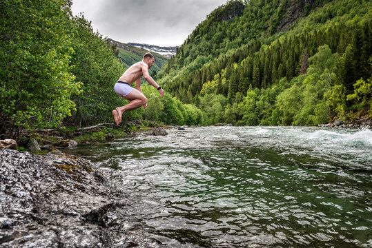 Man Jumping Into Cold Mountain River