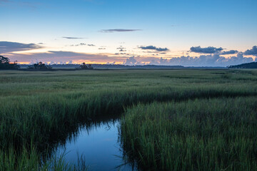 Fototapeta na wymiar Sunrise over the marsh along the Tolomato River in St. Augustine, Florida. 
