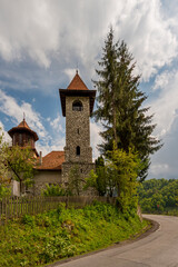 Fototapeta na wymiar Stone and wood orthodox church on a hill in the Carpathian Mountains in Transylvania in Romania