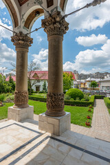 Stone columns with compound capitals at the entrance to a Romanian Orthodox church