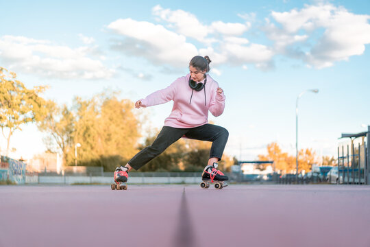 Female skater practicing stunt in park
