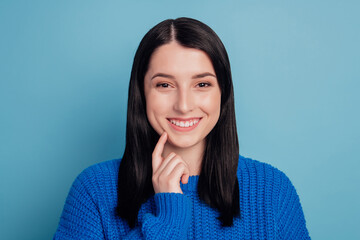 Fototapeta premium Photo of attractive young girl happy positive smile touch finger chin think thoughts isolated on blue color background