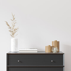 Empty white wall in scandinavian interior with black dresser, vase and decor. 