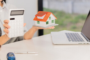 The sales representative offers a home purchase contract to purchase a house or apartment to...