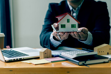 The sales representative offers a home purchase contract to purchase a house or apartment to...