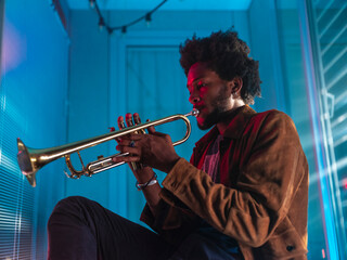 Young trumpeter performs at home