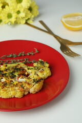 Concept of tasty food with baked cauliflower on white background.
