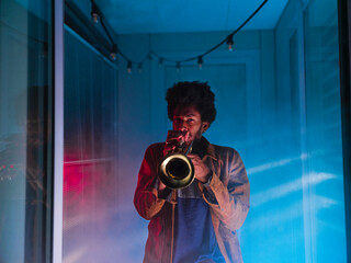 Young trumpeter performs at home