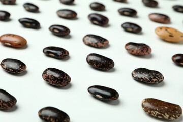 Flat lay composition with black beans on white background