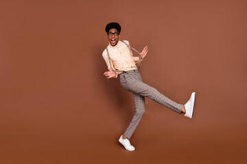 Fototapeta na wymiar Full length body size view of attractive cheerful carefree funky guy dancing having fun isolated over brown color background