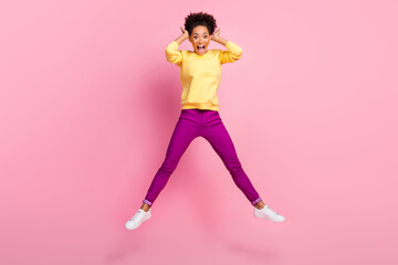 Fototapeta na wymiar Full size photo of impressed millennial brunette lady jump wear shirt jeans shoes isolated on pink background