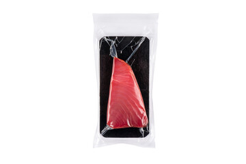 Yellow fin tuna steak in a plastic vacuum bag isolated on a white background. Vacuum packaged...