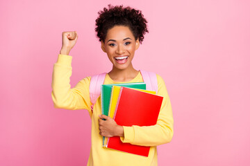 Photo of hooray young brunette lady hold books wear yellow shirt isolated on pink color background