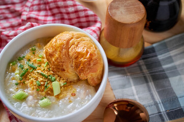 Porridge and croissant in white bowl