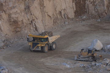 Dumper working over big rocks