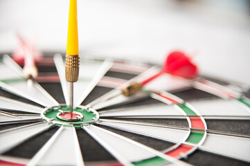 Close up of yellow dart on target with missing red