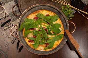 Brazilian pizza with sun-dried tomatoes, arugula and mozzarella