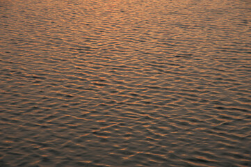 Ripples in the water with sunset scene