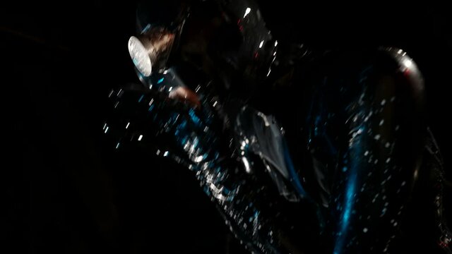 erotic fantasy with woman in latex bodysuit and full face mask, spit out white liquid