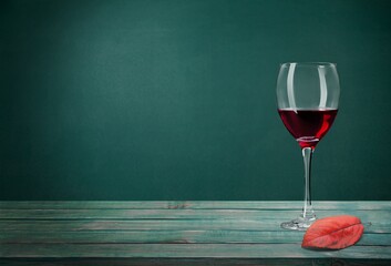 Wine glass with red wine and autumn leaves. Creative wine degustation