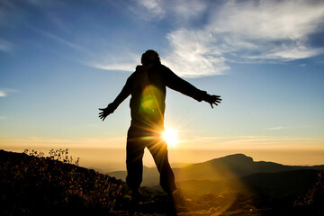 Man jumping on sunrise scene, famous mountain in north of Thailand