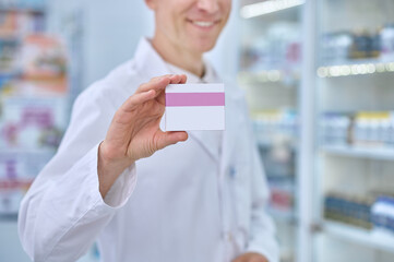 Male hand showing packaging of medicinal product