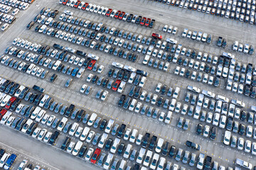 Fototapeta premium Aerial view New cars parked in ports preparing for export to foreign countries,concept about the automotive industry