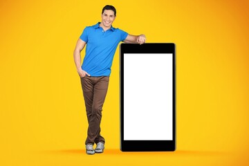 Happy guy leaning on huge smartphone with empty screen