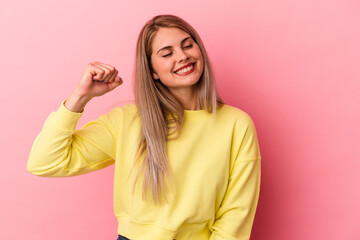 Young russian woman isolated on pink background celebrating a victory, passion and enthusiasm, happy expression.