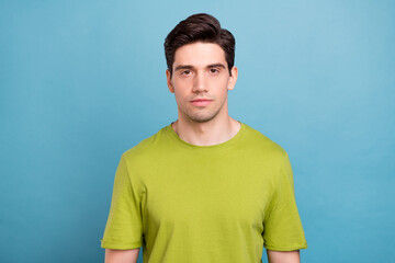Photo of rest millennial brunet guy wear green t-shirt isolated on blue color background