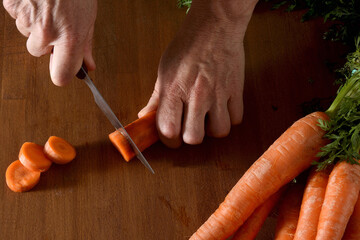 close up of high angle view of the cut of a carrots on a wood