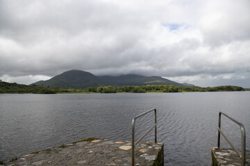 lake and mountains with boat deck