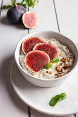 Delicious oatmeal porridge with fruits and nuts for breakfast