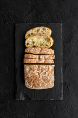 Freashly backed bread slice on cutting board, top view