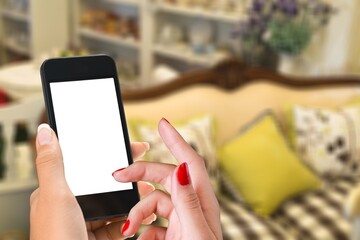 Human hand holding smartphone with white blank empty screen mockup, using smart at home